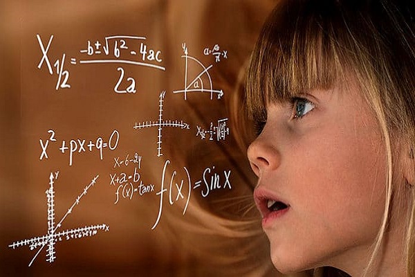 Девојче пред табла испишана со формули